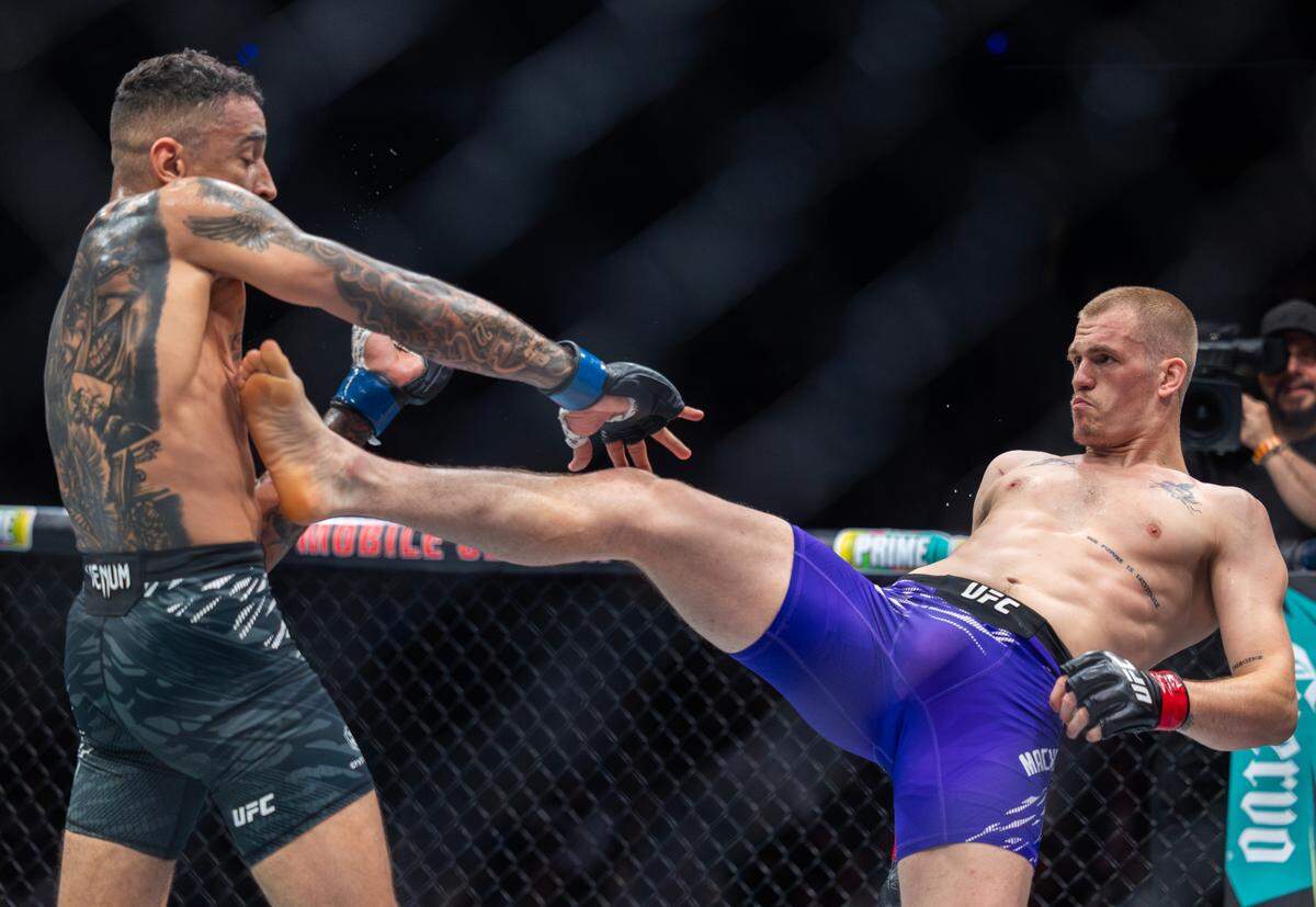 Ian Machado Garry kicks at fellow welterweight Carlos Prates during their main event fight at the T-Mobile Center in Kansas City on Saturday night during UFC Fight Night: Machado Garry vs. Prates. Machado Garry went on to defeat Prates.
