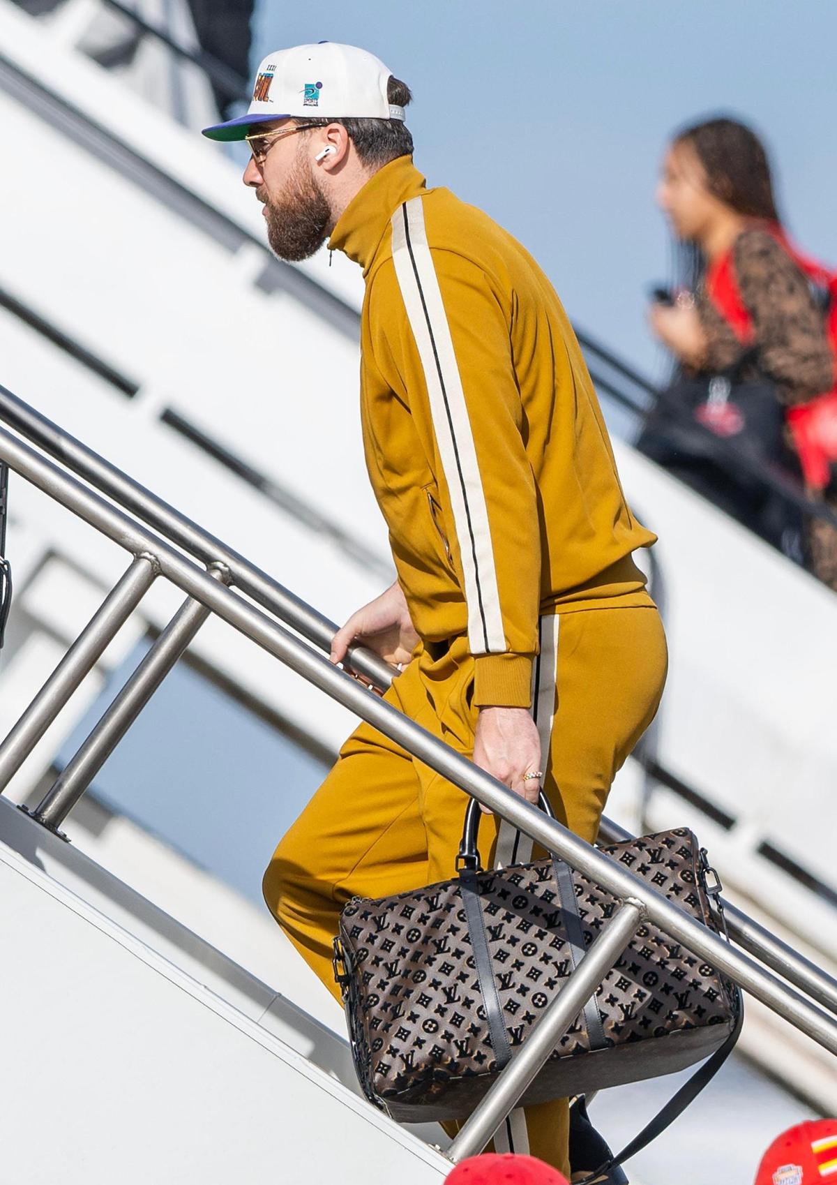 Kansas City Chiefs tight end Travis Kelce boards a plane with teammates from Kansas City International Airport on Sunday, Feb. 2, 2025, to travel to New Orleans for Super Bowl LIX.
