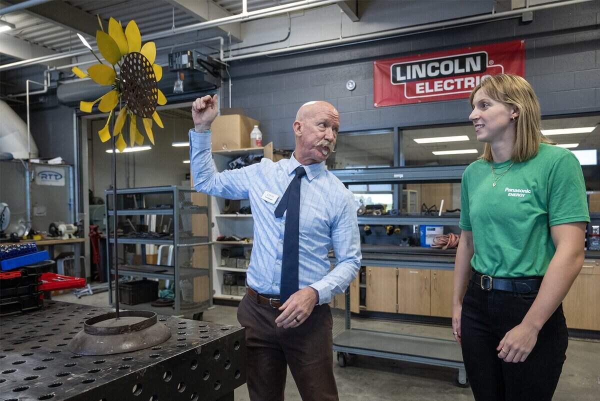 Tim Mispagel, right, Career & Technical Education Administrator, at Cedar Trails Exploration Center (CTEC) CAPS, gives a tour to Olympic swimmer and Panasonic ambassador Katie Ledecky, who visited the facility on Tuesday, Sept. 30, 2025, in Lenexa. Ledecky was on hand to meet and learn from students in STEM program in the DeSoto School District.