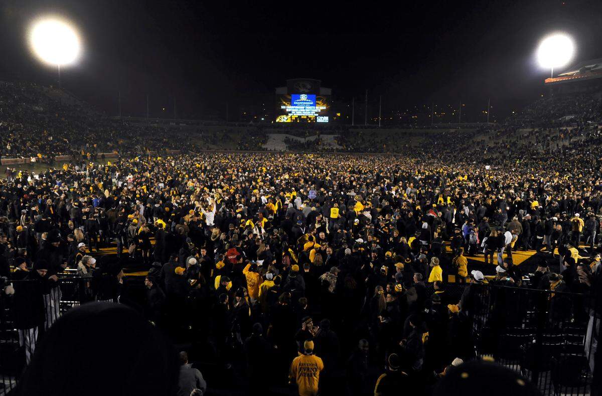 Fans celebrate on the field following Missouri’s 28-21 victory over Texas A&M in an NCAA college football game on Saturday, Nov. 30, 2013, in Columbia, Mo. (AP Photo/L.G. Patterson)