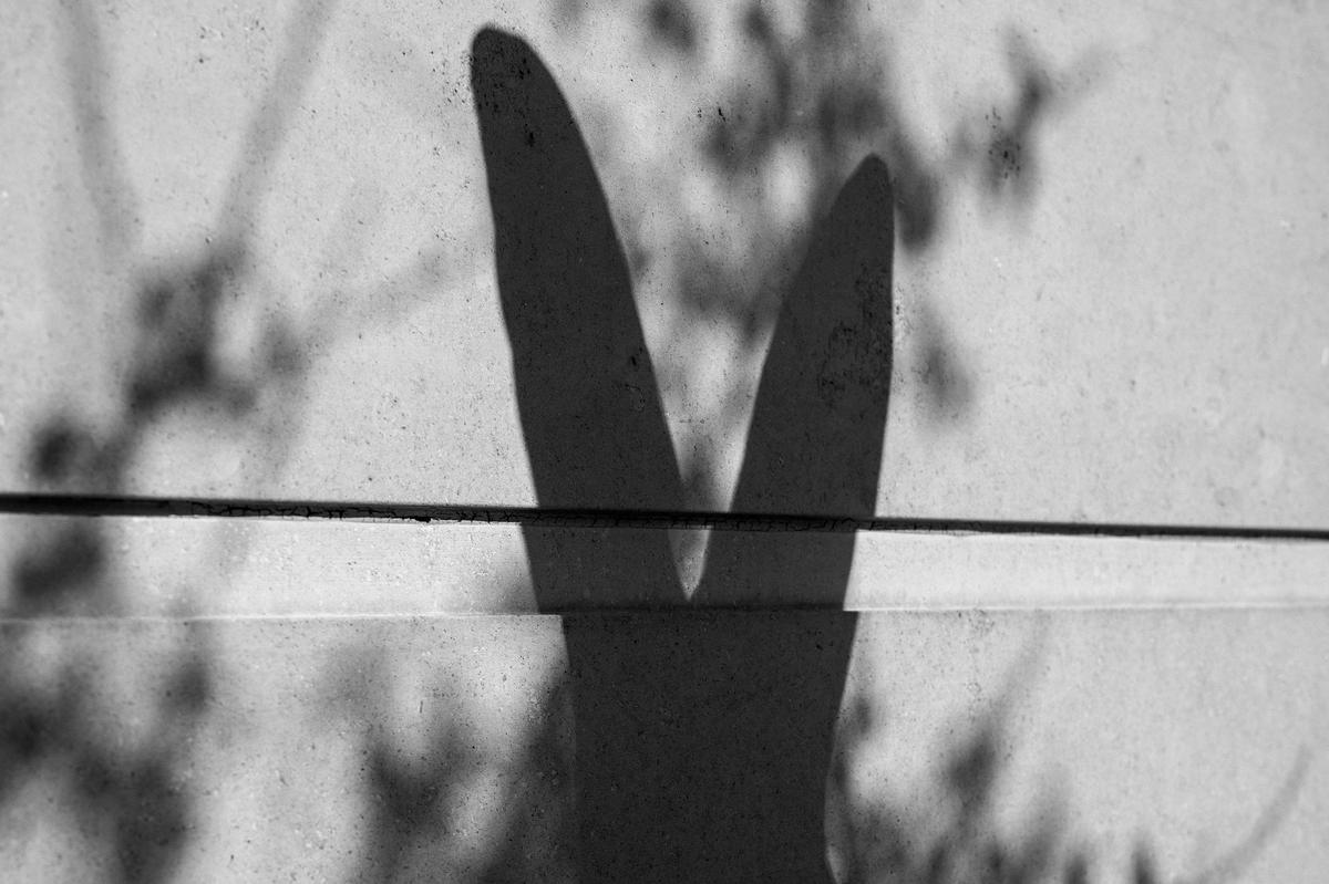 An Easter bunny sculpture casts a shadow on a wall at the Country Club Plaza.