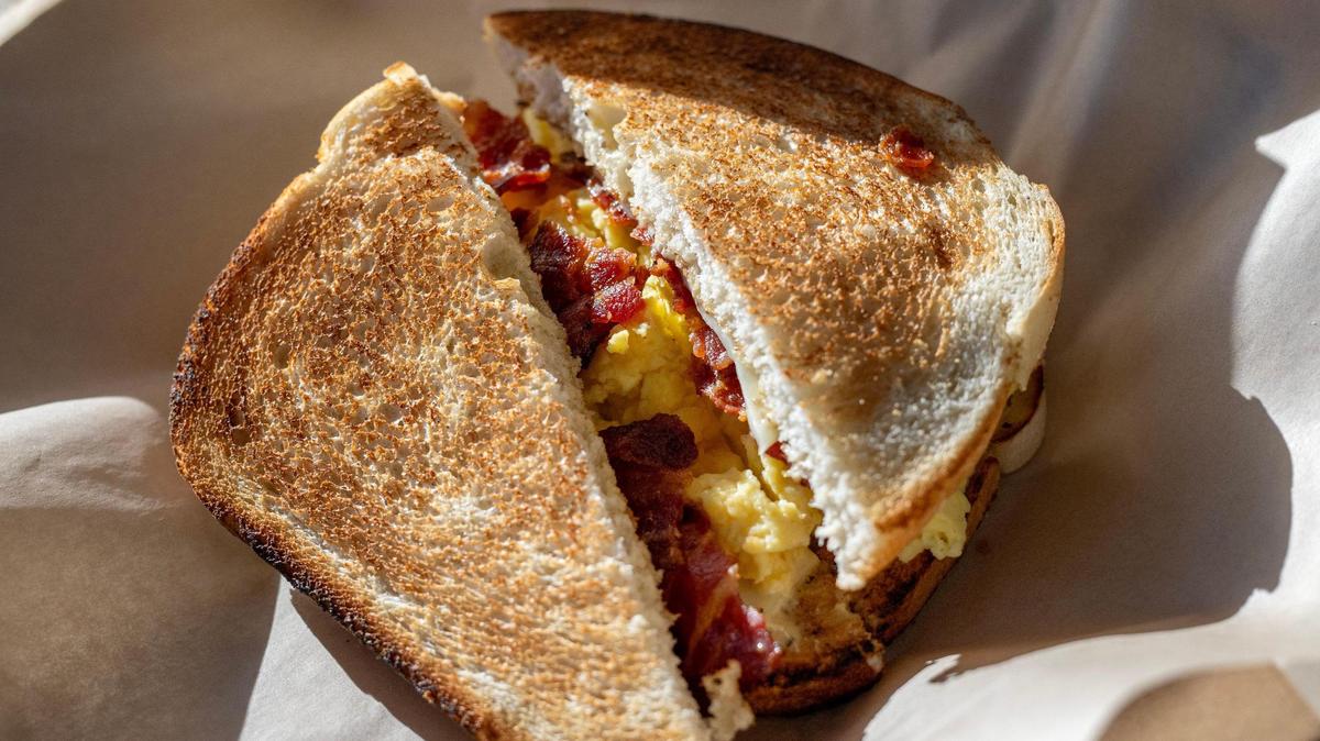 The standard sandwich, which includes steamed eggs, bacon, American Swiss and Dijon mayo on a choice of wheat, sourdough, marble rye, jalapeño, ciabatta, or brioche bun, is served at Mildred’s on Thursday in Kansas City.