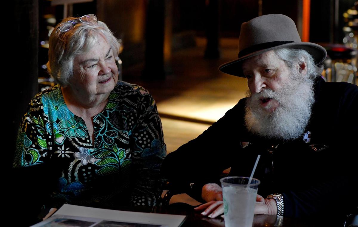 Marge Finley, left, and David Duncan visit with other members of the Squirrel table during a recent reunion at Kelly’s.