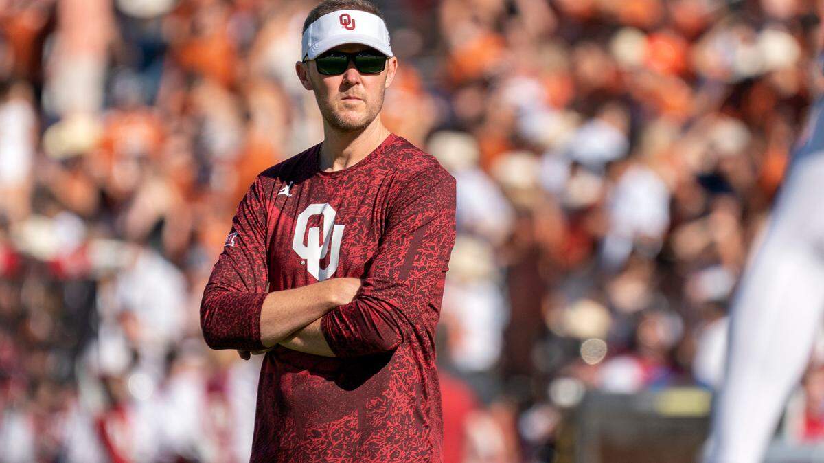 Oklahoma head coach Lincoln Riley watches his team warm up before an NCAA college football game against Texas at the Cotton Bowl, Saturday, Oct. 9, 2021, in Dallas. Oklahoma won 55-48. (AP Photo/Jeffrey McWhorter)