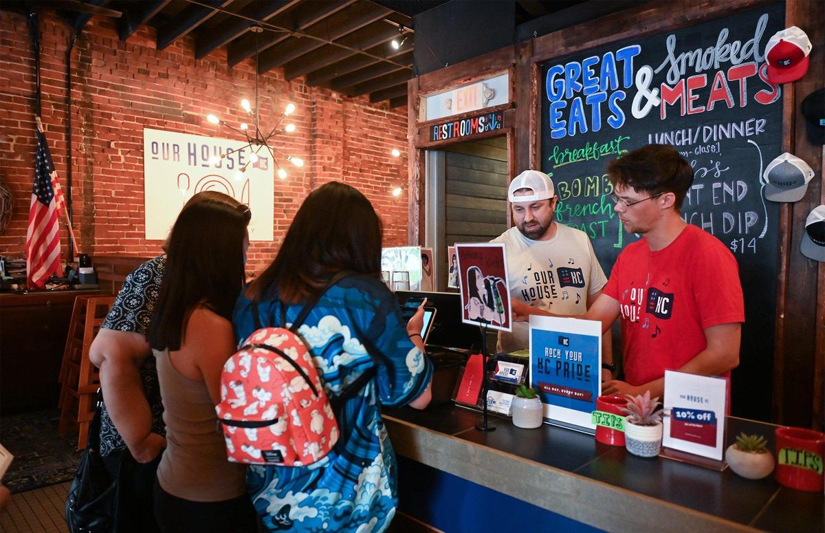 Behind the counter, owner Joe Zahner, left, helps with an order at OurHouse KC, 1815 W. 39th St., a restaurant he opened with his wife, Maggie Zahner.