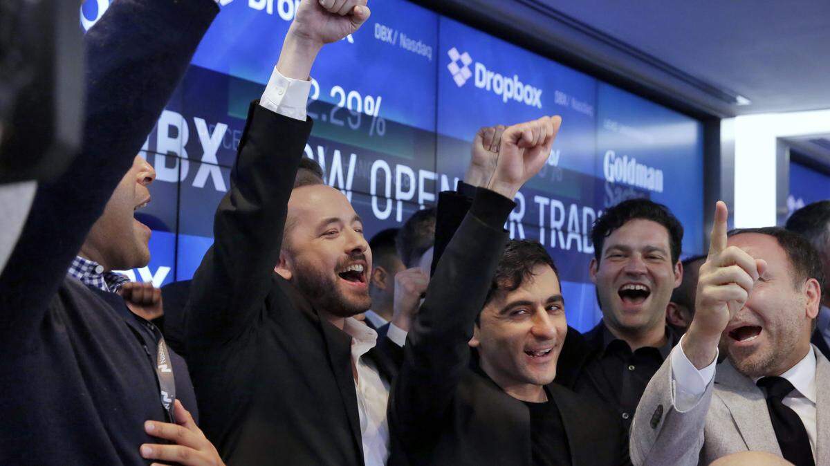 Dropbox co-founders Drew Houston (second from left) and Arash Ferdowsi of Overland Park (third from left) celebrated with Dropbox executives as their company began trading on the stock market on Friday, March 23.