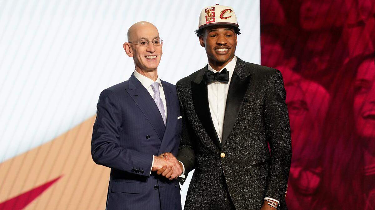 Ochai Agbaji is congratulated by NBA Commissioner Adam Silver after being selected 14th overall by the Cleveland Cavaliers in the 2022 NBA Draft in New York.