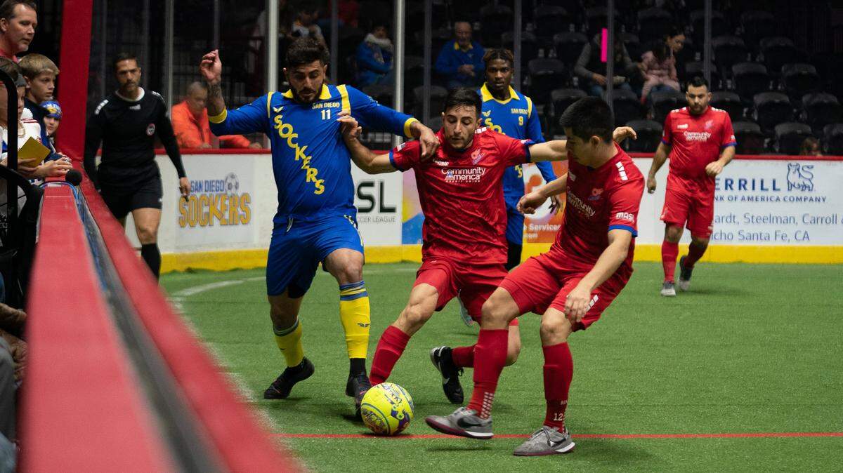 Comets players Christian Anderaos (left) and Benji Monreal (right) battle the San Diego Sockers for the ball.