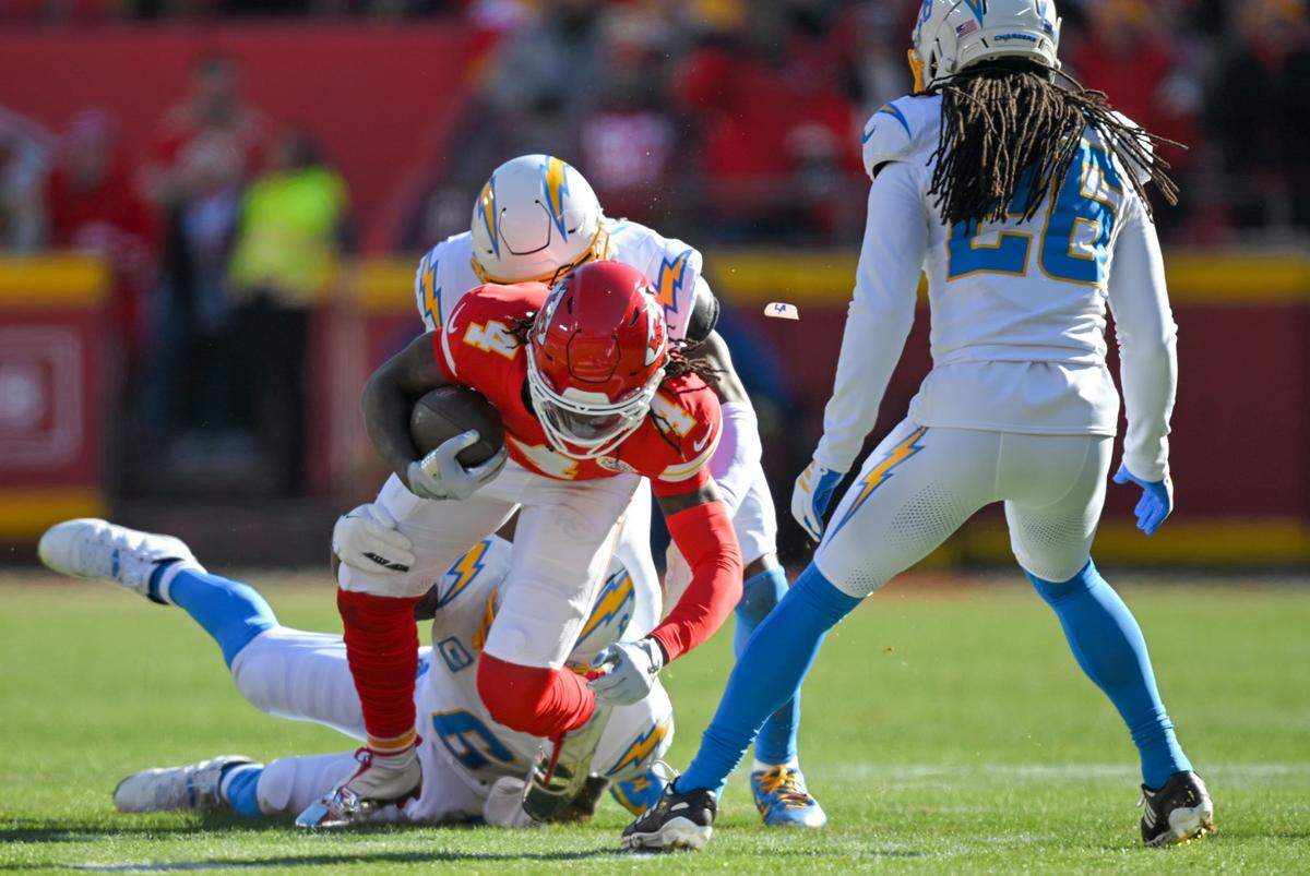 Kansas City Chiefs wide receiver Rashee Rice (4) is tackled in the first quarter against the LA Chargers at GEHA Field at Arrowhead Stadium on Sunday, Dec. 14, 2025.
