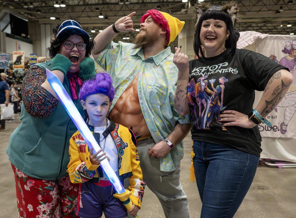 Anne McKim, left, her husband, John, her daughter, Emily, and their friend, Kylie Wilbur, dress as characters from the movie “K-Pop Demon Hunters” during Planet Anime at the Kansas City Convention Center on Saturday, Nov. 22,