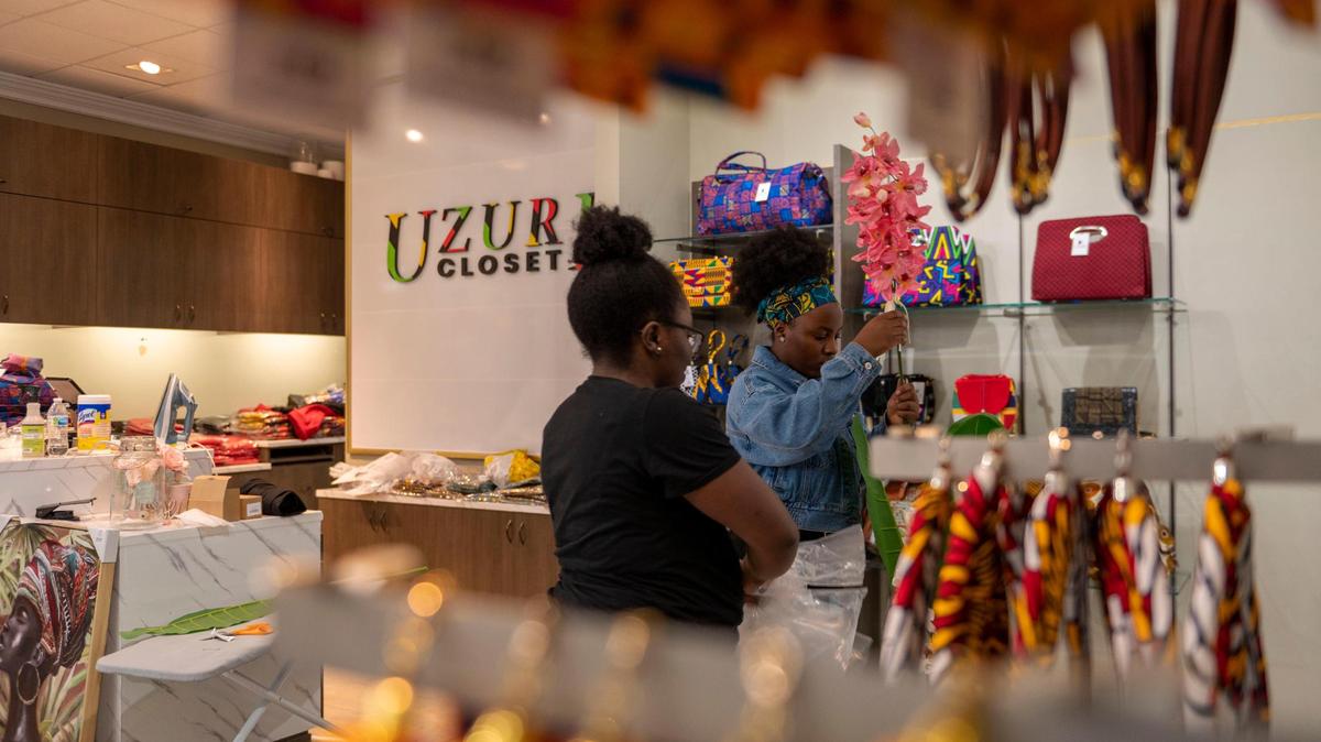 Melanie Mfuh, left, and Laura Nsoh-Awasom work at their new store, Uzuri Closet, in Oak Park Mall. It sells African-inspired clothing and accessories.