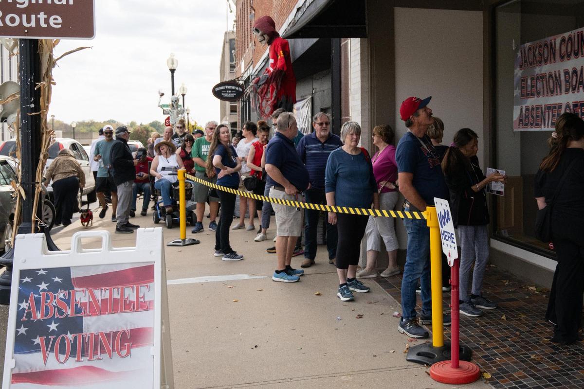 Voters form a line that snakes around the block during early voting at the Jackson County Election Board office polling station in Independence on Tuesday, Oct. 29. Some voters waited up to three hours to cast their vote.