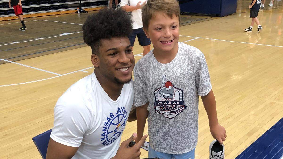 Kansas Jayhawks freshman forward Zuby Ejiofor posed for a picture with a camper on Tuesday at Brett Ballard’s Washburn camp for youths.