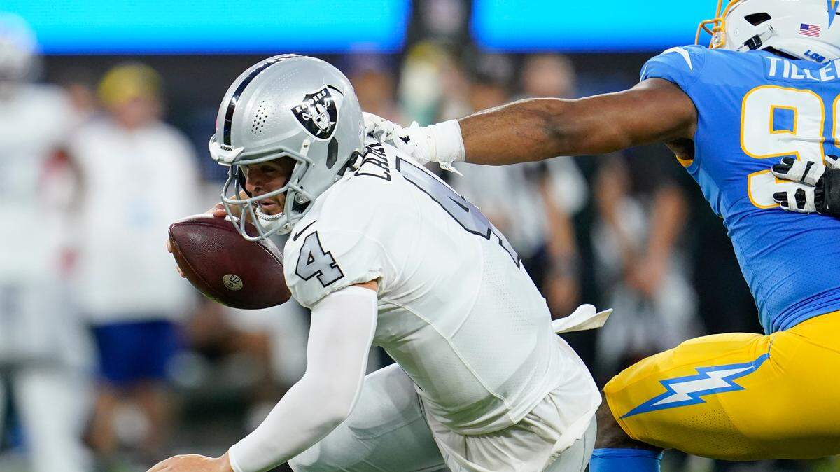 Las Vegas Raiders quarterback Derek Carr tries to get away from Los Angeles Chargers defensive tackle Jerry Tillery during the first half of an NFL football game Monday, Oct. 4, 2021, in Inglewood, Calif. (AP Photo/Marcio Jose Sanchez)