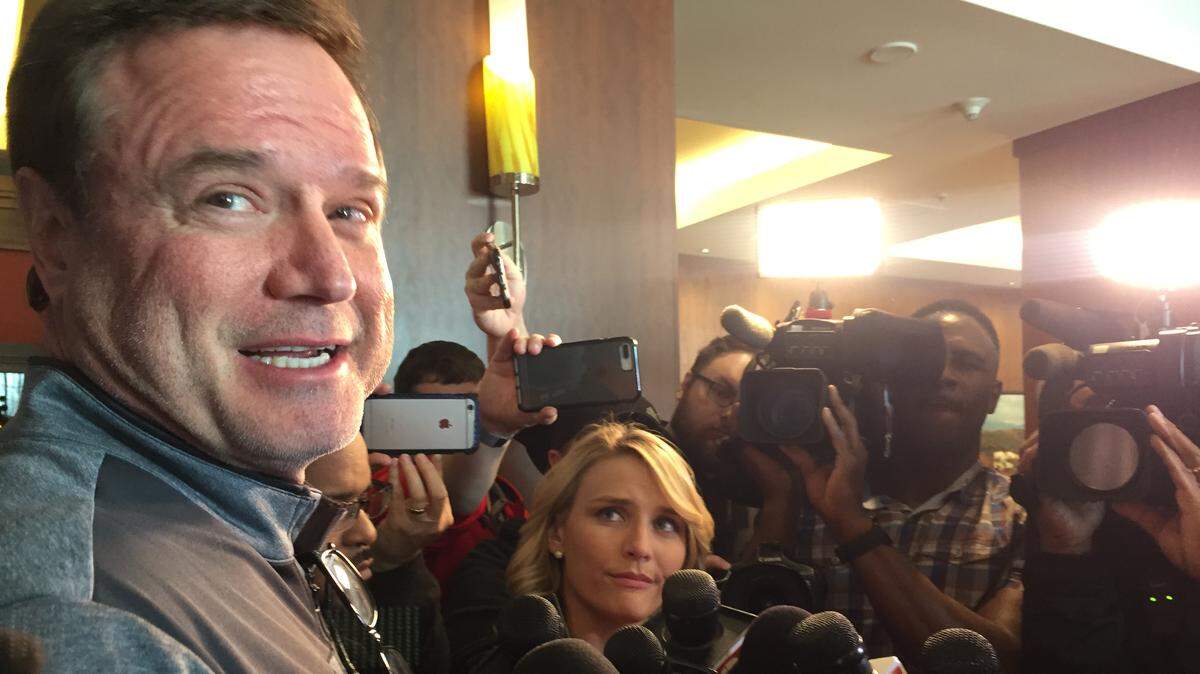 Kansas basketball coach Bill Self smiles while speaking to a reporter in front of a throng of television cameras shortly after the team’s arrival at the Hilton Salt Lake City Center in Salt Lake City on Tuesday afternoon. KU will face Northeastern on Thursday in the opening round of the NCAA Tournament.