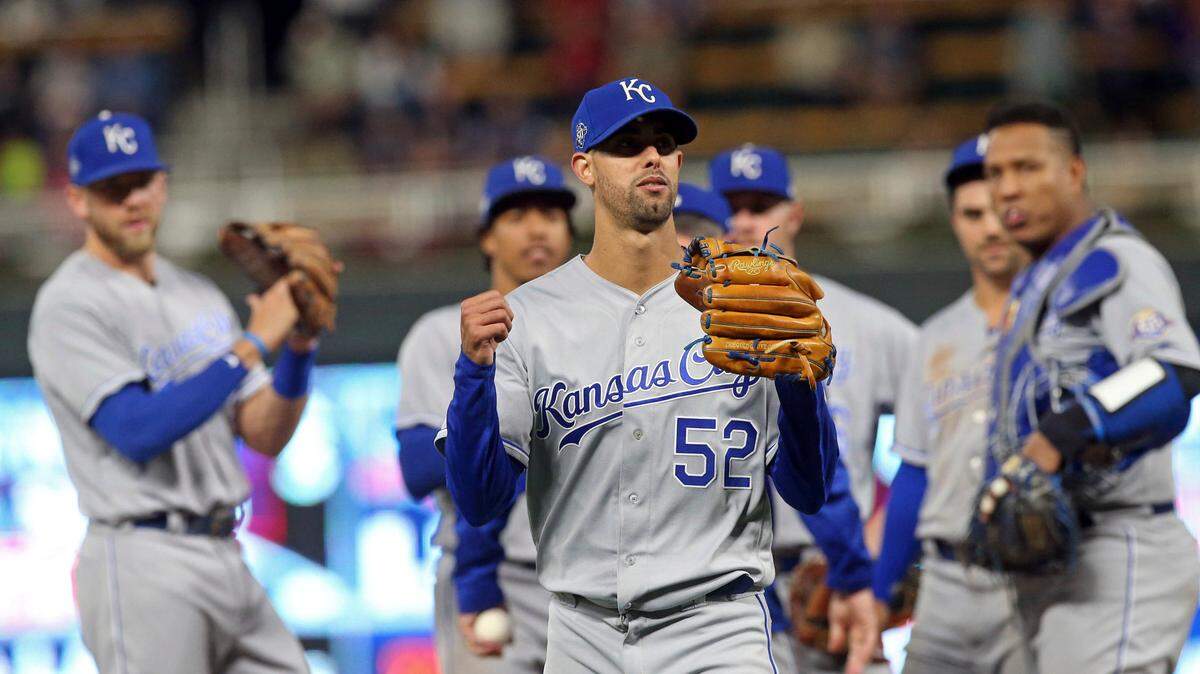Pitcher Jorge Lopez (center) left after he was pulled in the ninth inning against the Minnesota Twins. Lopez had a perfect game through eight innings but gave up a walk and a hit in the ninth. The Royals won 4-1.