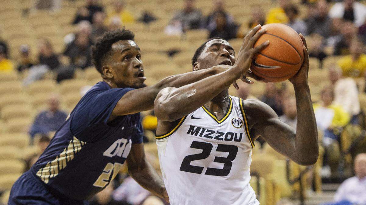 Oral Roberts’s Kerwin Smith, left, fouls Missouri’s Jeremiah Tilmon, right, who was trying to shoot during the first half of an NCAA college basketball game Friday, Dec. 7, 2018, in Columbia, Mo. (AP Photo/L.G. Patterson)