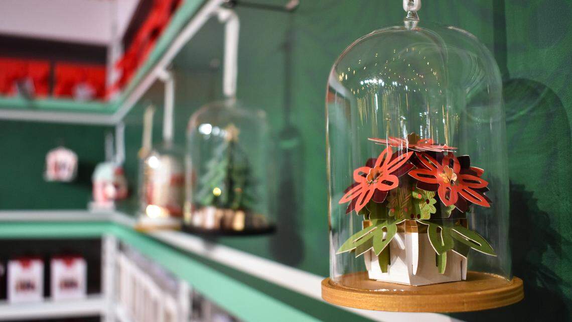 A paper poinsettia ornament is displayed in the Hallmark pop-up shop inside the free Hallmark Christmas Experience, which runs in Kansas City’s Crown Center every weekend from Nov. 29 until Dec. 22.