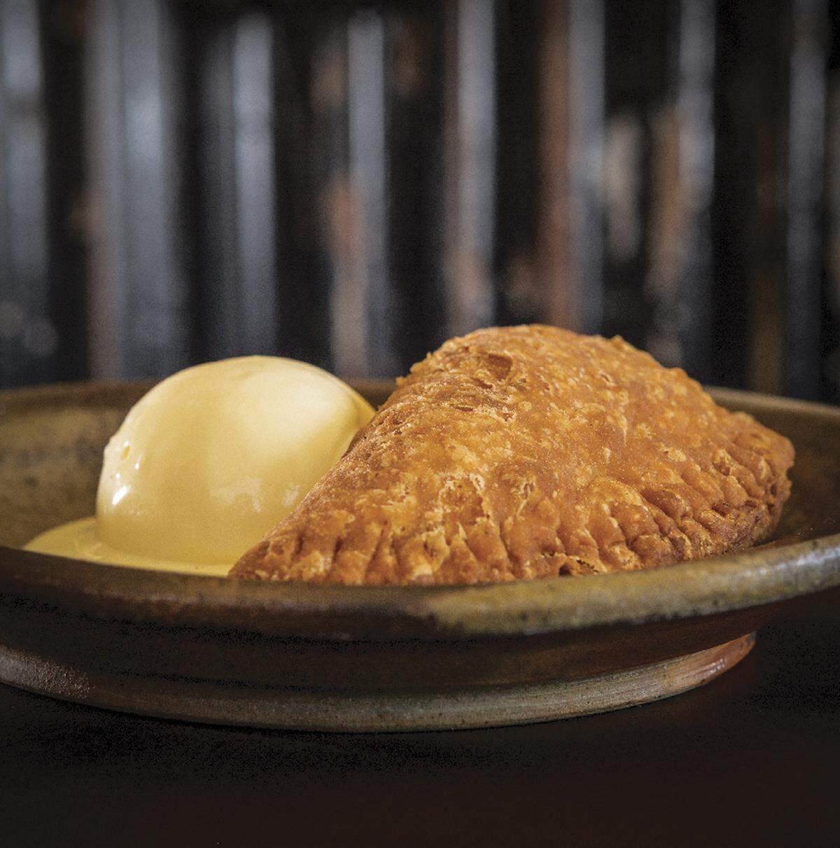 Fox and Pearl’s summer menu features peach hand pie served with creme fraiche ice cream.