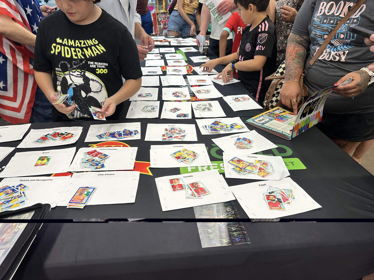 White papers divide the Panini World Cup stickers by country to make it easier  at a Panini World Cup sticker trading event held at World Fresh Market in Overland Park on June 14.