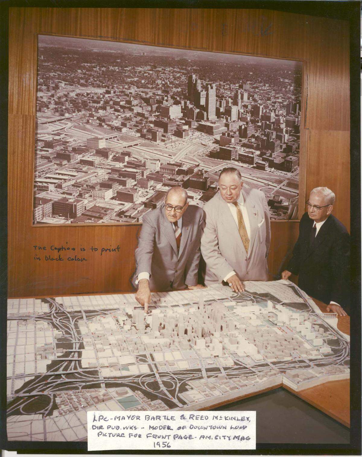 City Manager L.P. Cookingham, Mayor H. Roe Bartle, and Public Works Director Reed McKinley examine a model of the downtown expressway loop. Mayor Bartle’s right hand rests near the section of the loop that would cut through the West Side.