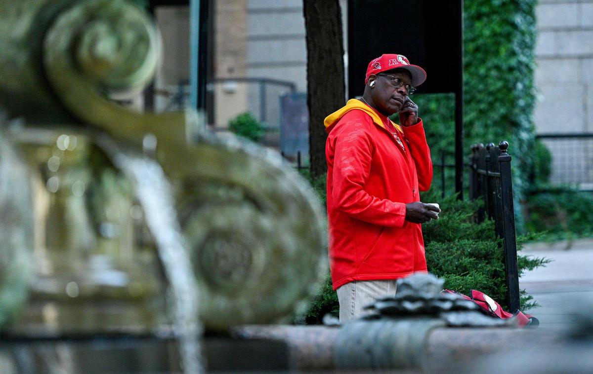 Robert Lewis puts his earbuds in while waiting for a bus at 10th and Main streets in Kansas City. He listens to music during his long ride to work in Olathe, a commute he has been making for more than 20 years.