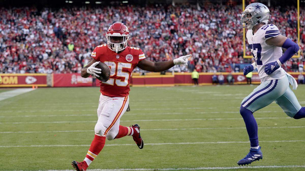 Kansas City Chiefs running back Clyde Edwards-Helaire (25) celebrates as he scores past Dallas Cowboys linebacker Luke Gifford (57) during the first half of an NFL football game Sunday, Nov. 21, 2021, in Kansas City, Mo. (AP Photo/Charlie Riedel)