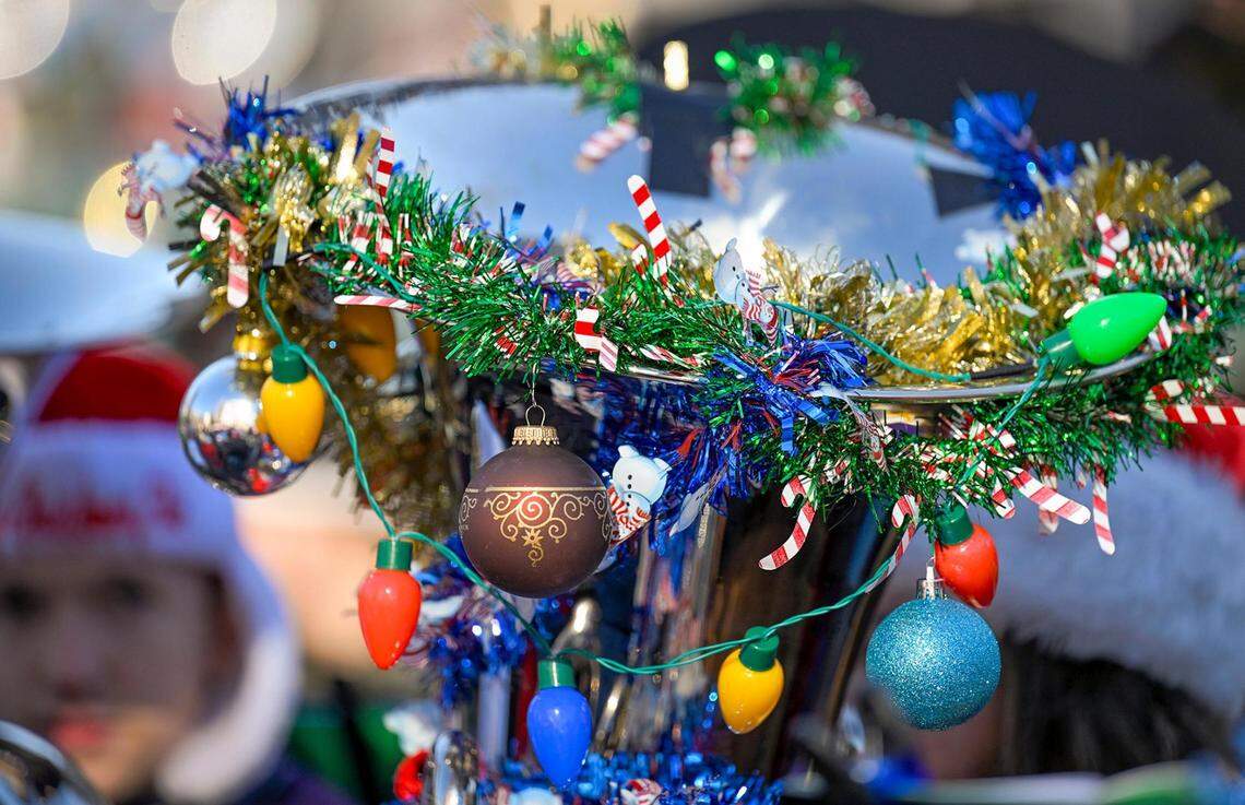 Holiday decorations including Christmas lights adorned some of the instruments of local tuba and euphonium players gathered Tuesday in the Crown Center Square for their annual TubaChristmas holiday concert.