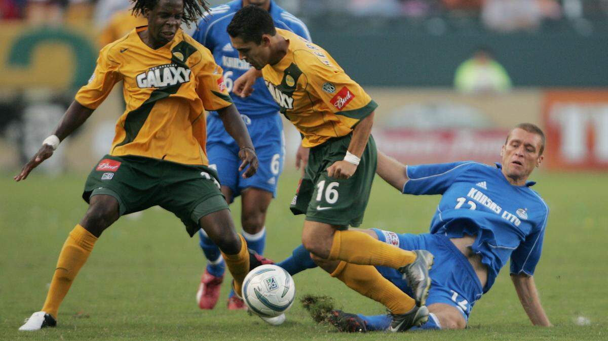 Kansas City Wizards’ Jimmy Conrad kicks the ball away from Los Angeles Galaxy’s Joseph Ngwenya and Herculez Gomez, during the secon period, Sunday, Sept. 25, 2005, in Carson, Calif. (AP Photo/Jeff Lewis)