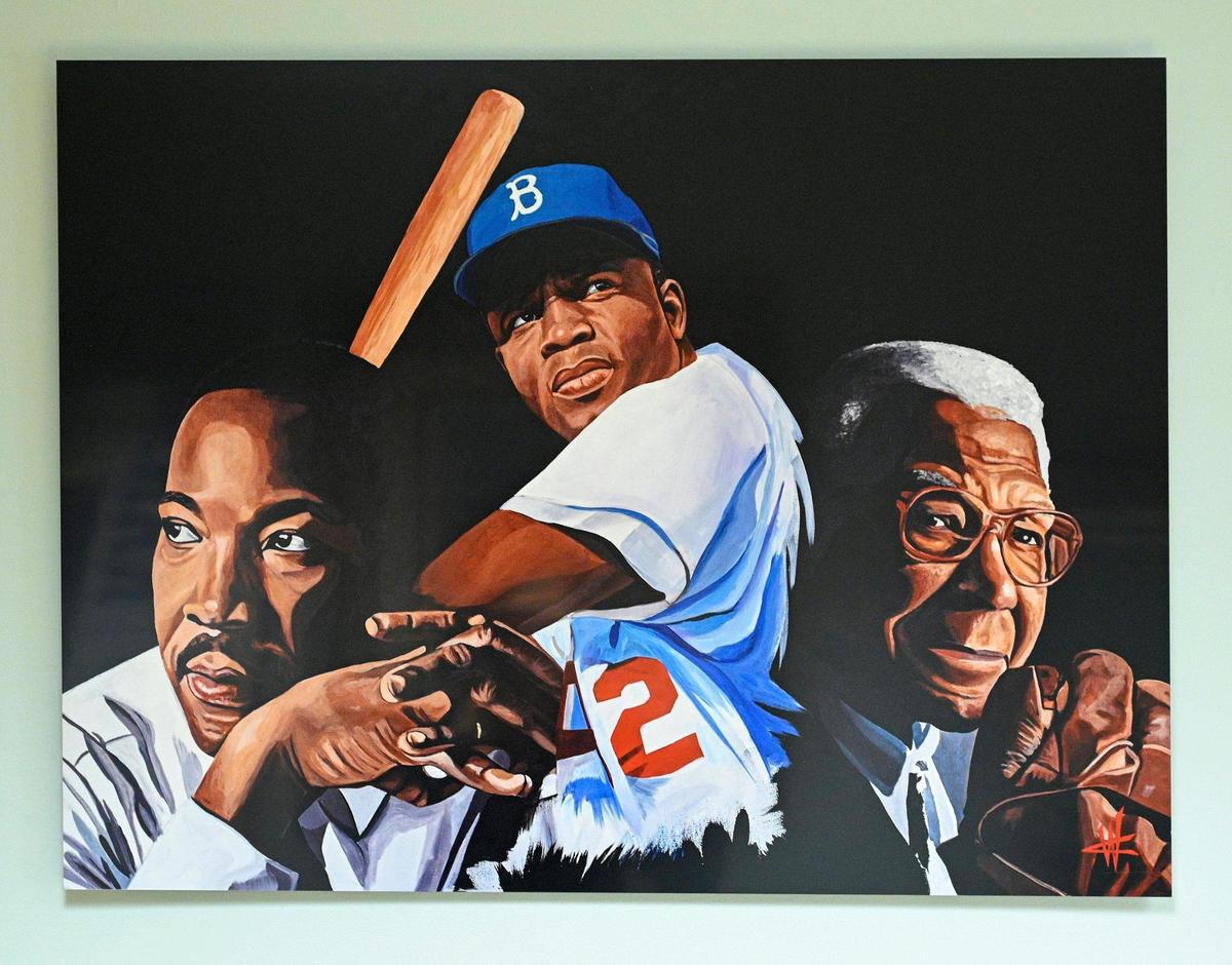 A painting of Martin Luther King Jr., Jackie Robinson and Buck O’Neil by Courtney Wall hangs in the office of Bob Kendrick, president of the Negro Leagues Baseball Museum.