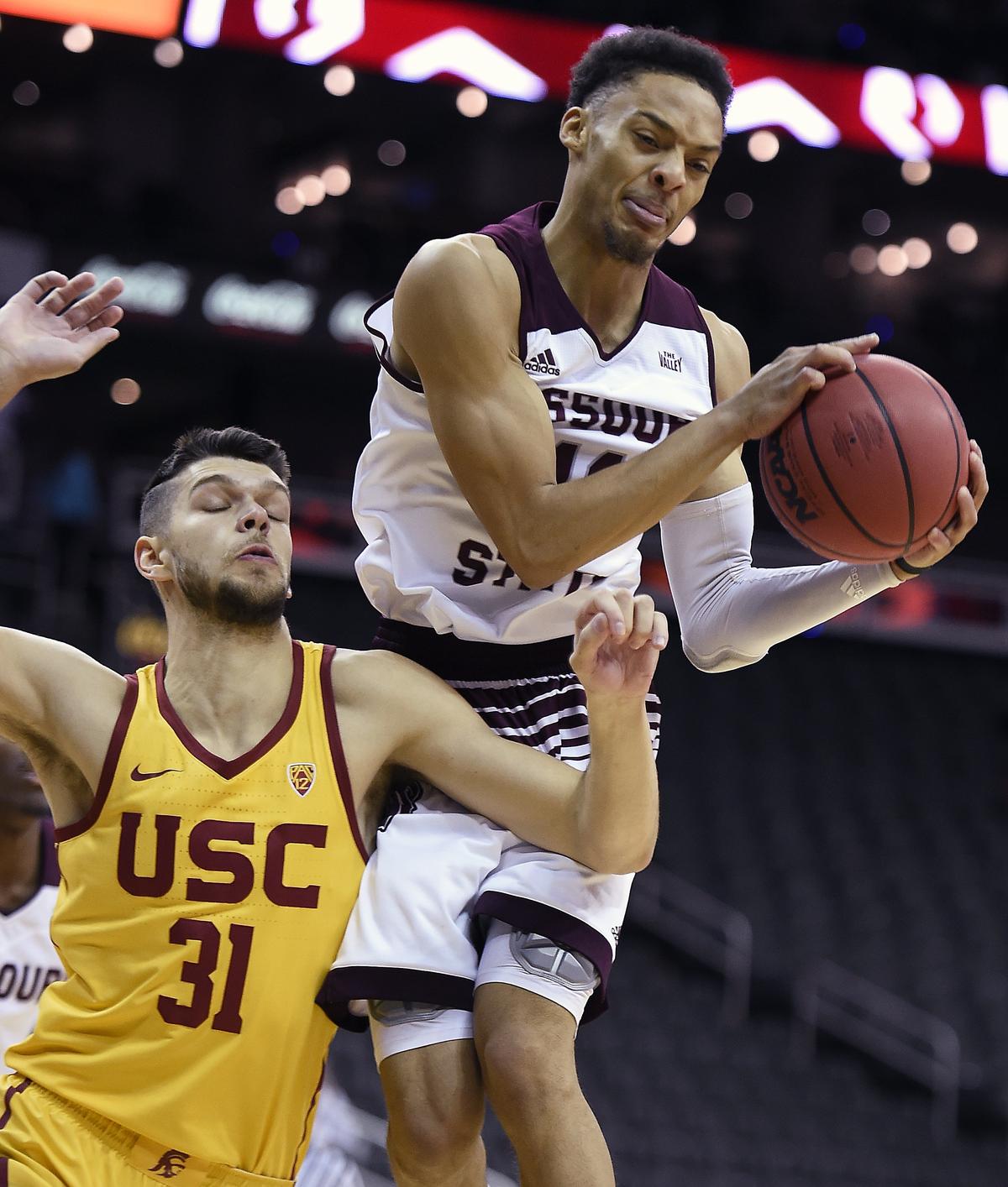 Missouri State’s Jarred Dixon, right, snares a rebound away from USC’s Nick Rakocevic Tuesday night at Sprint Center.