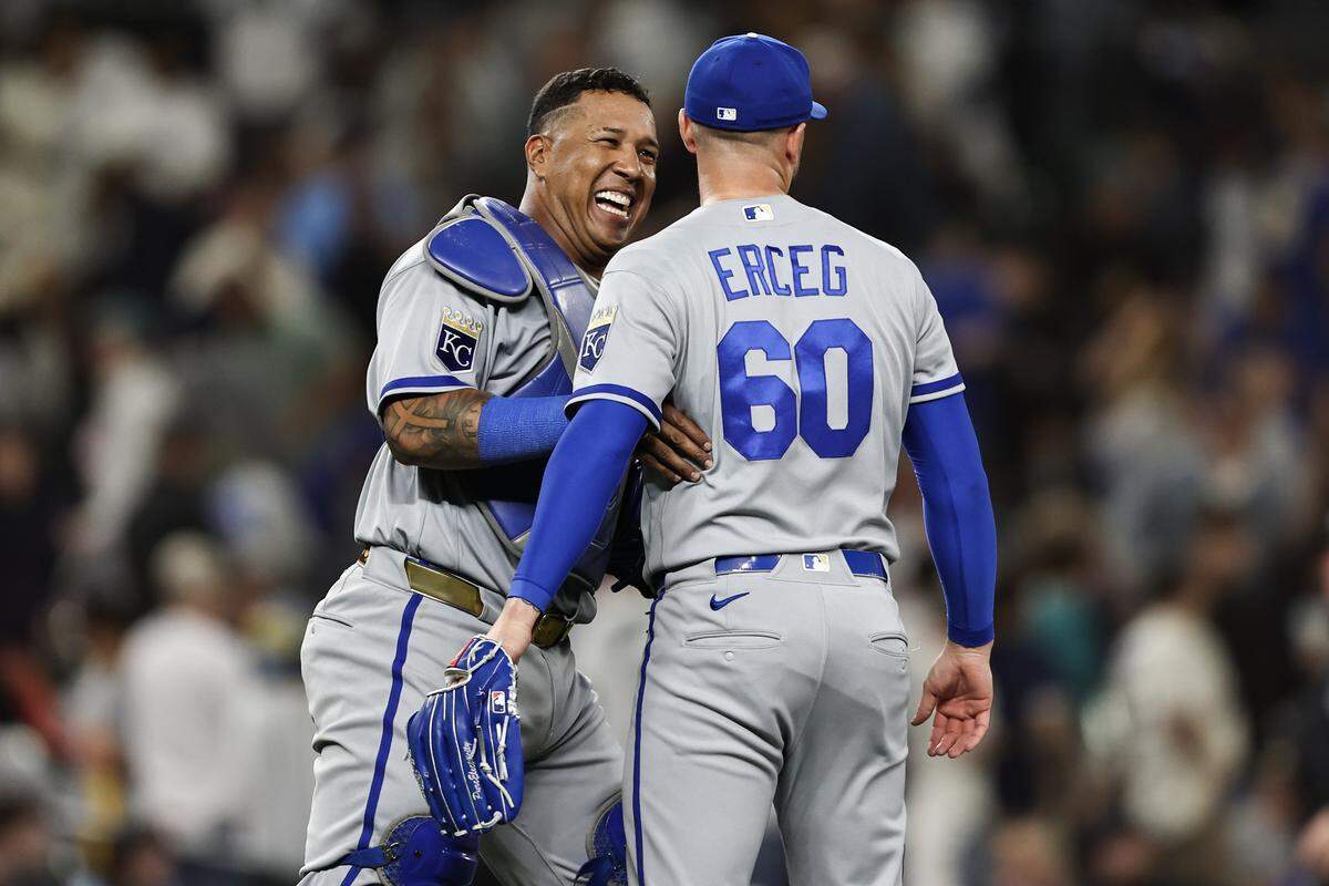 Salvador Perez, left, celebrates with Royals reliever Lucas Erceg after a 7-6 win over the Mariners at T-Mobile Park in Seattle on Friday, May 1, 2026.