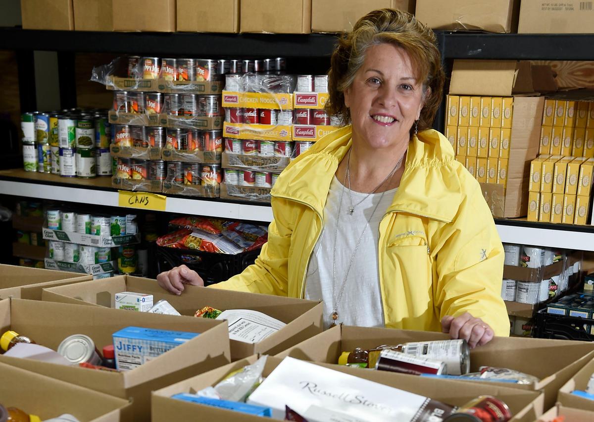 When the COVID-19 crisis shut down her job as a nurse anesthesiologist, Christine Johnson, 56, volunteered her time at the Community Services League food pantry in Independence.
