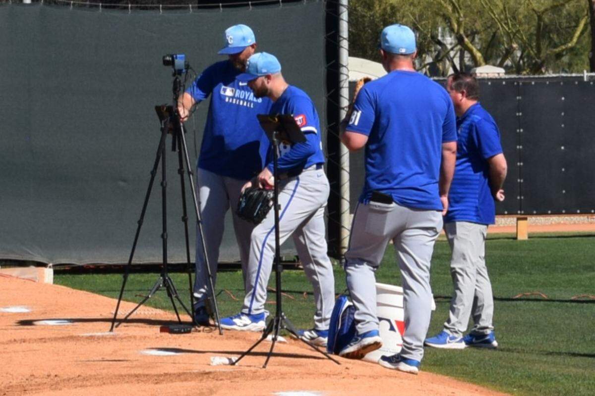Kansas City Royals pitcher Thomas Hatch (38) looks at instant feedback from the TrackMan system and Edgertronic cameras during a bullpen session at the club’s spring training complex in Surprise, Arizona.