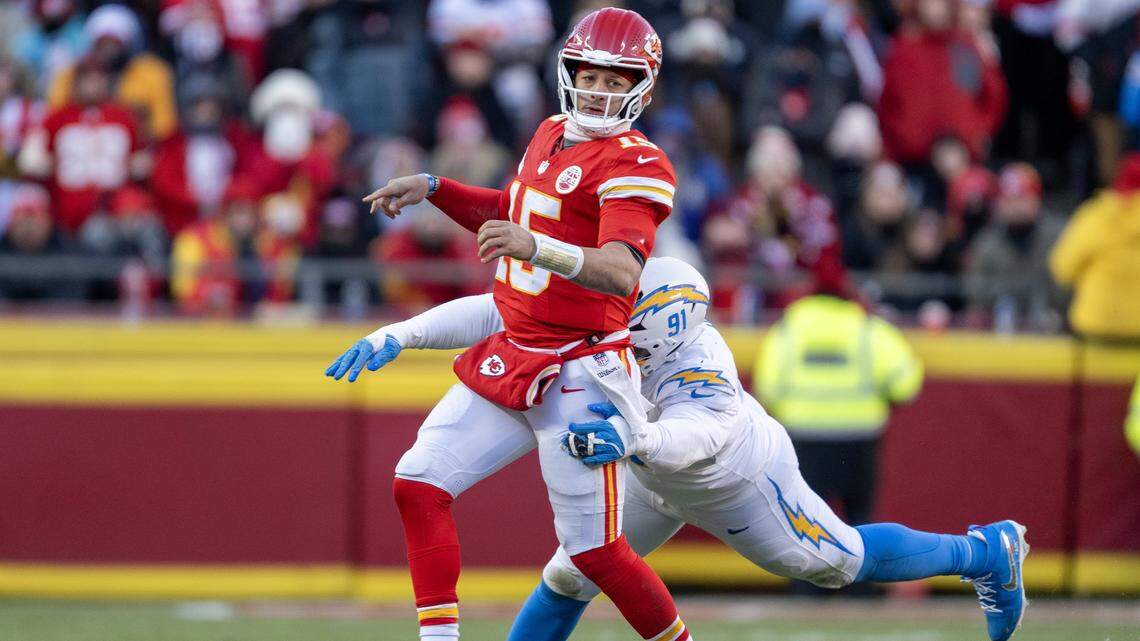 Kansas City Chiefs quarterback Patrick Mahomes (15) got a pass after as Los Angeles Chargers defensive tackle Da'Shawn Hand (91) tackled him in the second half on Sunday, Dec. 14, 2025 at GEHA Field at Arrowhead Stadium in Kansas City. The Chargers defeated the Chiefs, 16-13.