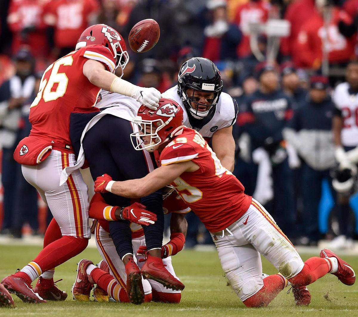 Kansas City Chiefs linebacker Ben Niemann (56) and defensive back Daniel Sorensen (49) forced a fumble from Houston Texans wide receiver DeAndre Carter in the second quarter.