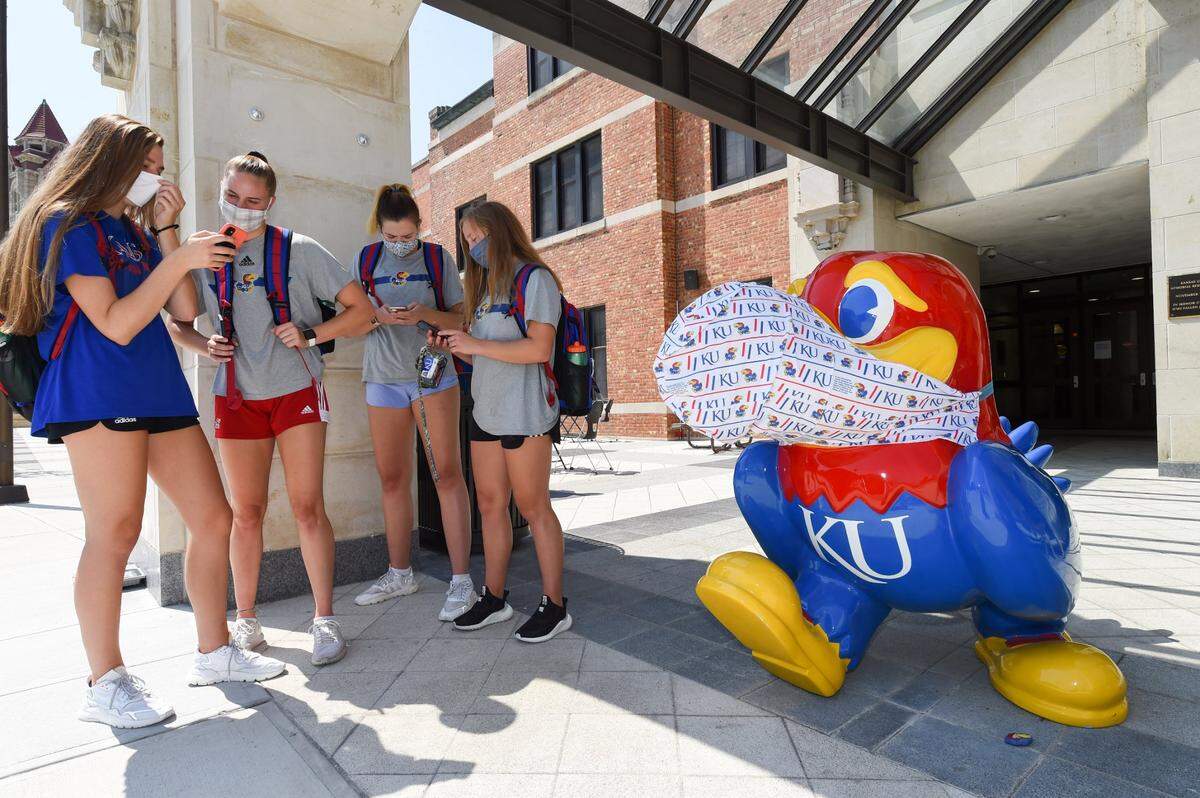 On the first day of classes, Karli Schmidt, from left, Jenny Mosser, Anezka Szabo and Molly Schultz, all members of the University of Kansas volleyball team, waited for a bus on campus last week.