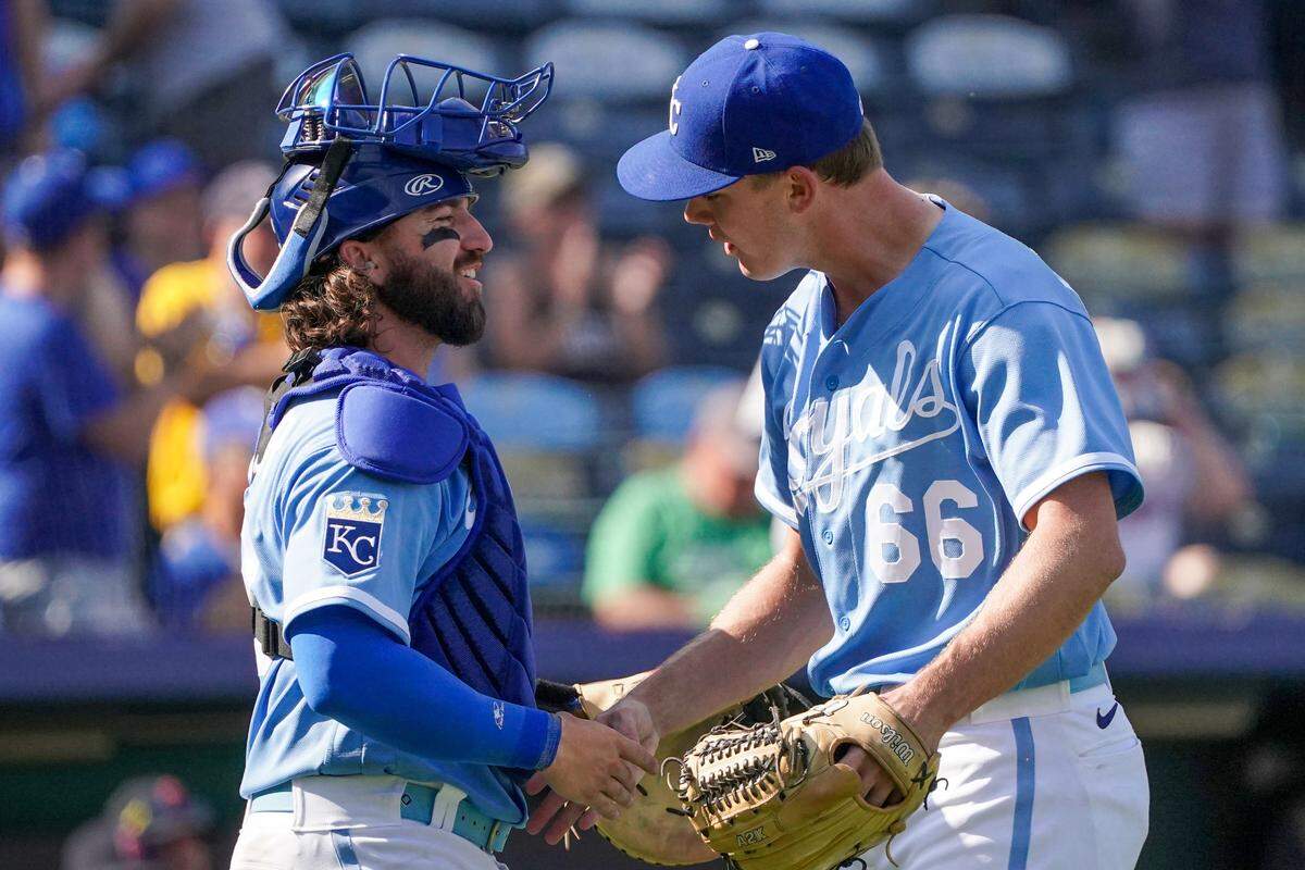 Kansas City Royals relief pitcher James McArthur (66) celebrates with catcher Logan Porter (88) after defeating the Cleveland Guardians at Kauffman Stadium on Sept. 18, 2023.