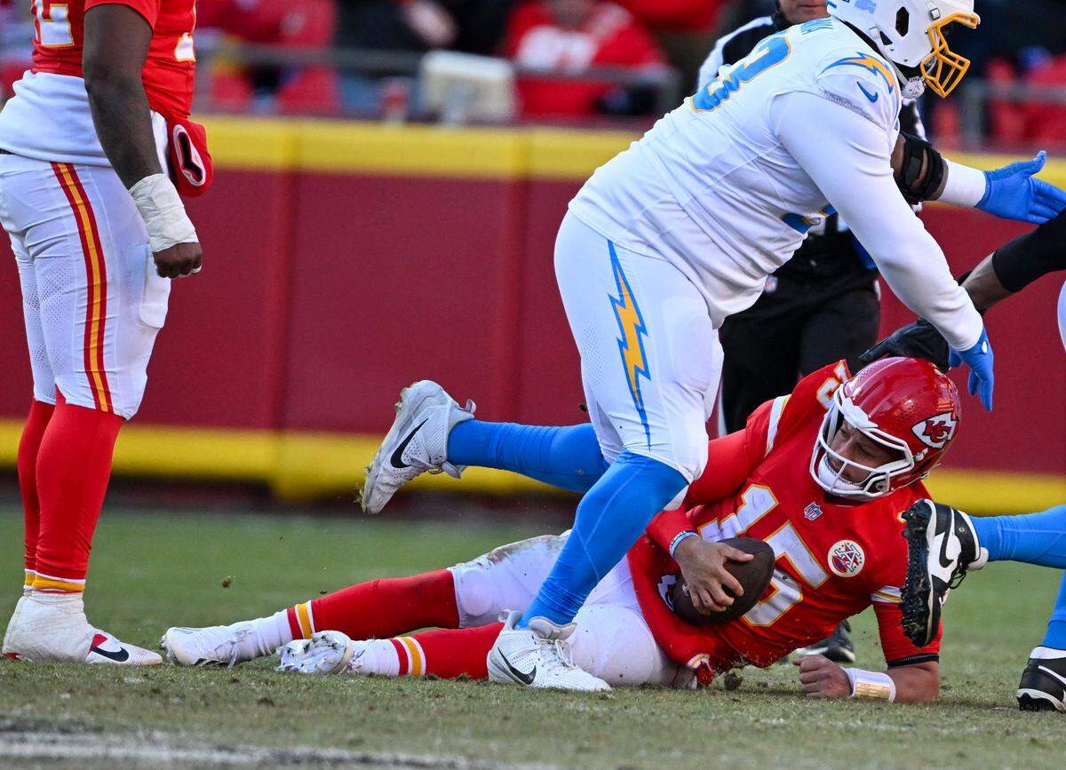 Kansas City Chiefs quarterback Patrick Mahomes (15) is sacked in the second half against the LA Chargers at GEHA Field at Arrowhead Stadium on Sunday, Dec. 14, 2025.
