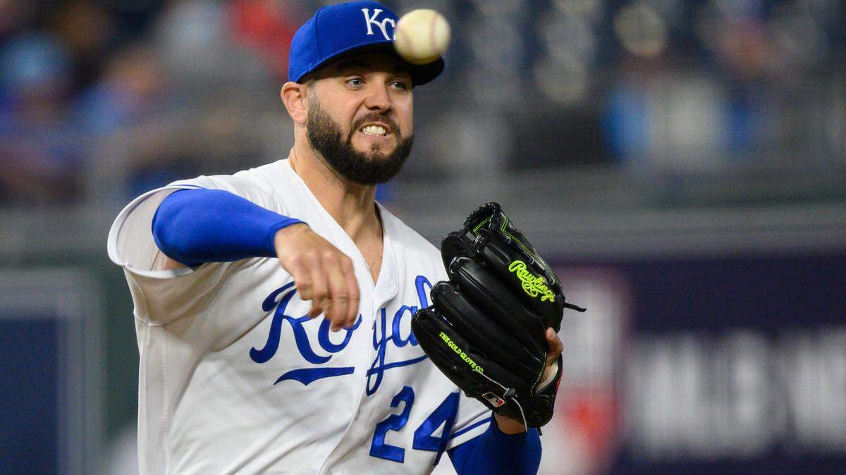 Kansas City Royals starting pitcher Jakob Junis tries to pick off Cleveland Indians’ Cesar Hernandez on first base during the seventh inning of a baseball game against the Cleveland Indians Monday, May 3, 2021, in Kansas City, Mo. (AP Photo/Reed Hoffmann)