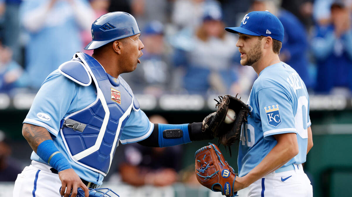 Kansas City Royals catcher Salvador Perez, left, talks with pitcher Collin Snider, right, during a baseball game against the Cleveland Guardians in Kansas City, Mo., Saturday, April. 9, 2022. (AP Photo/Colin E. Braley)