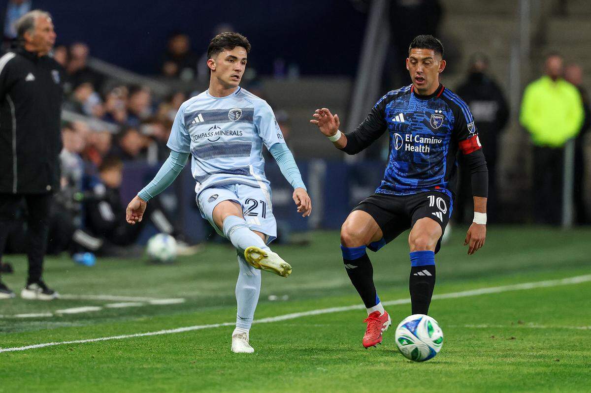 Sporting Kansas City midfielder Manu Garcia (21) passes the ball in front of San Jose Earthquakes forward Cristian Espinoza (10) during the first half at Children’s Mercy Park on March 1, 2025.