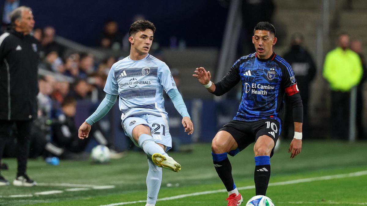Sporting Kansas City midfielder Manu Garcia (21) passes the ball in front of San Jose Earthquakes forward Cristian Espinoza (10) during the first half at Children’s Mercy Park on March 1, 2025.