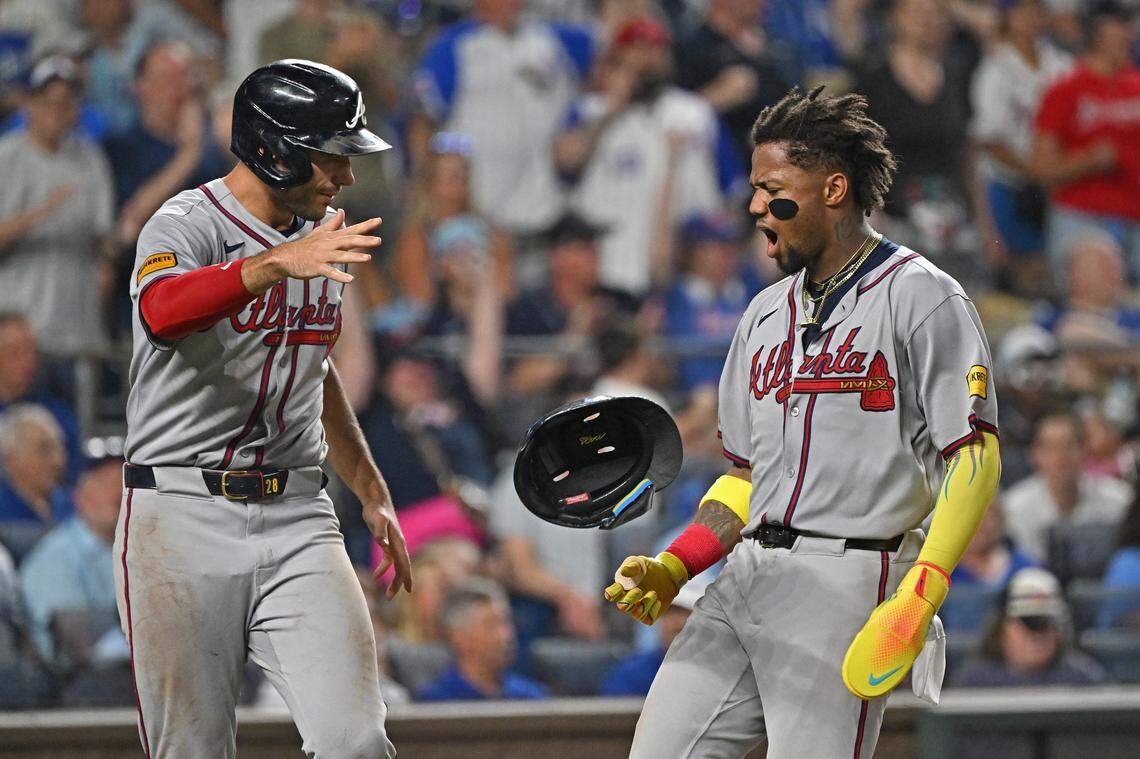 Jul 28, 2025; Kansas City, Missouri, USA;  Atlanta Braves right fielder Ronald Acuna Jr. (13) celebrates with teammate first baseman Matt Olson (28) scoring a run in the eighth inning against the Kansas City Royals at Kauffman Stadium. Mandatory Credit: Peter Aiken-Imagn Images