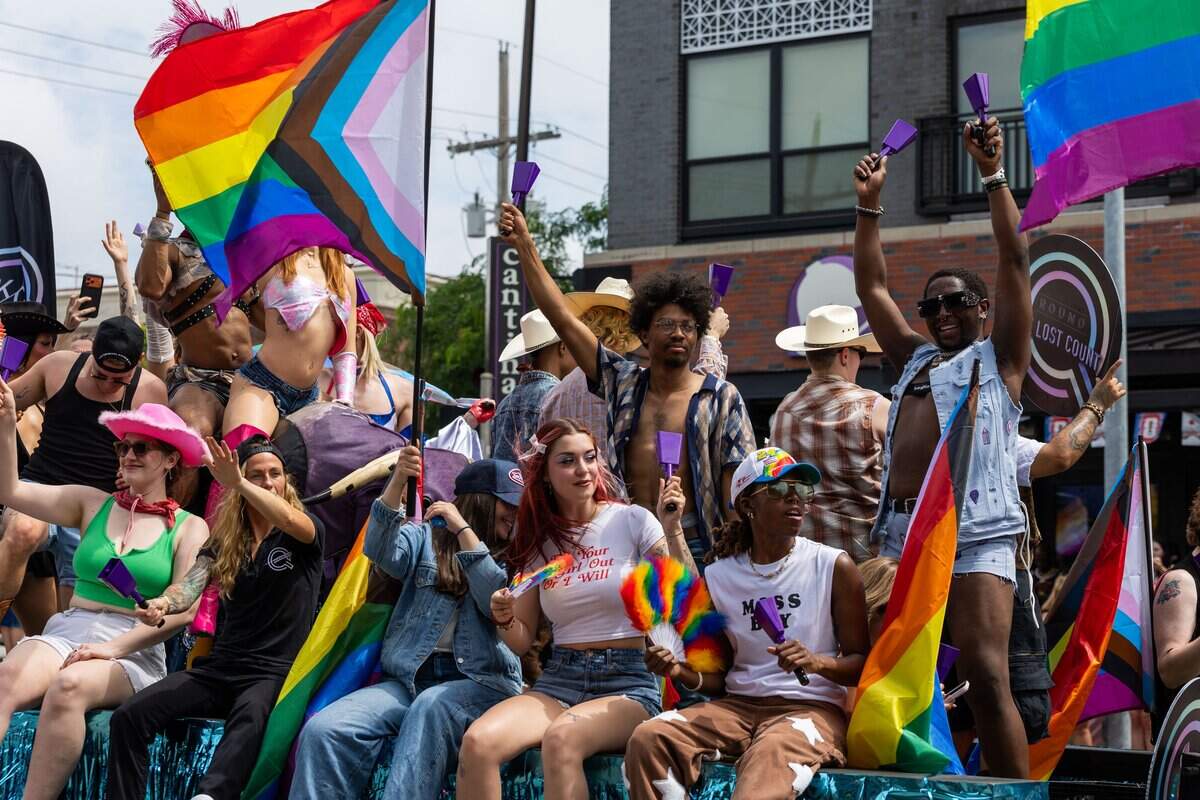 Parade attendees dance and cheer on their float as they make their way through Kansas City's Annual Pride Parade at Westport Rd on Saturday, June 6, 2026.