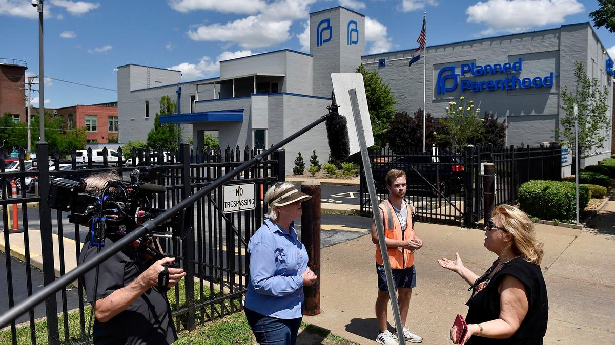 Lucy Kay of Chesterfield, right, felt compelled to speak with anti-abortion protesters Mary Gardner of St. Louis, left, and Ben Gruender of Hazelwood after leaving a large protest against Missouri’s restrictive law at the arch in St. Louis, Thursday, May 30, 2019.