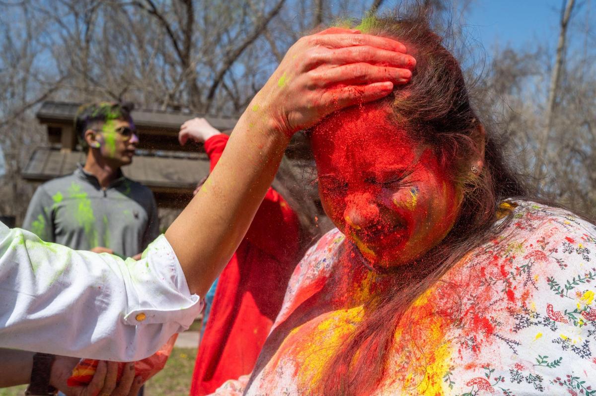 A participant in the Hindu celebration of Holi in Overland Park on Sunday gets her face covered in colorful powder.
