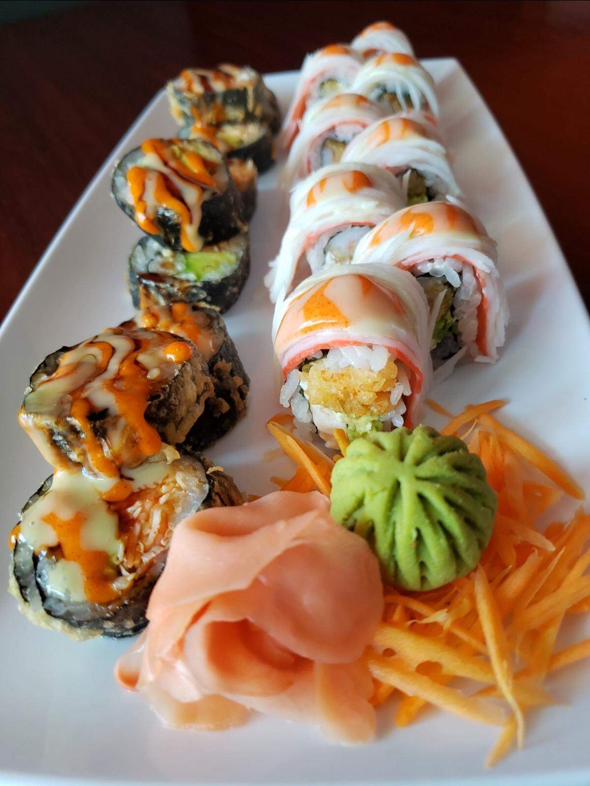 Cozy Thai’s KC Roll, left, with shrimp tempura, cream cheese and avocado topped with crab, and its deep fried JB roll with salmon and cream cheese, dipped in tempura batter, deep fried and topped with unagi sauce.