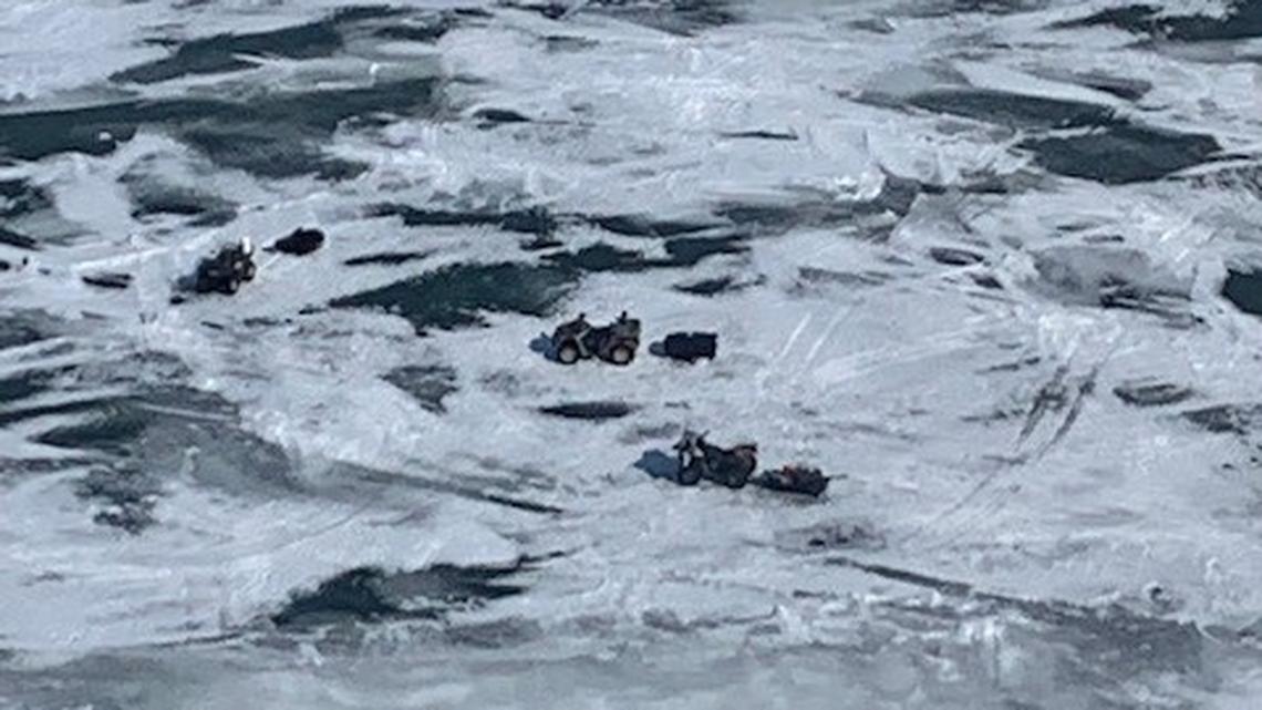 Seven people snowmobiling and riding ATVs were rescued after a sheet of ice broke free in Lake Erie, officials say.