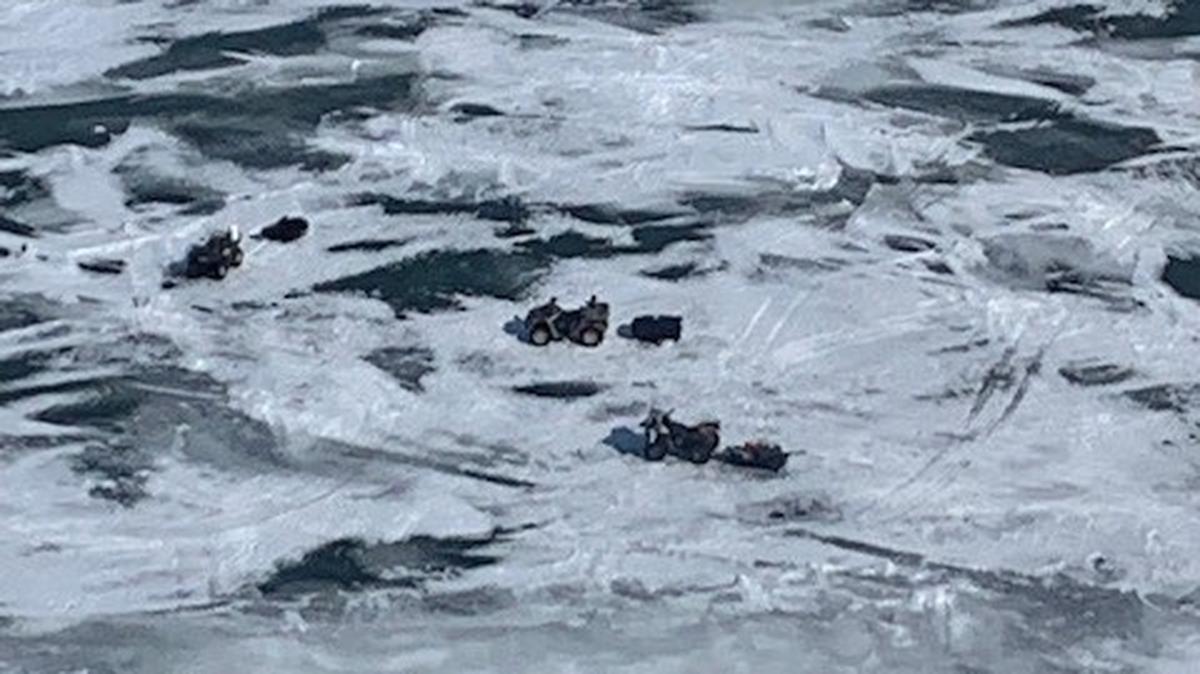 Seven people snowmobiling and riding ATVs were rescued after a sheet of ice broke free in Lake Erie, officials say.